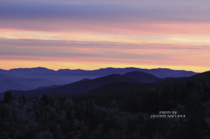 Mountain silhouette against a colorful sunset sky.